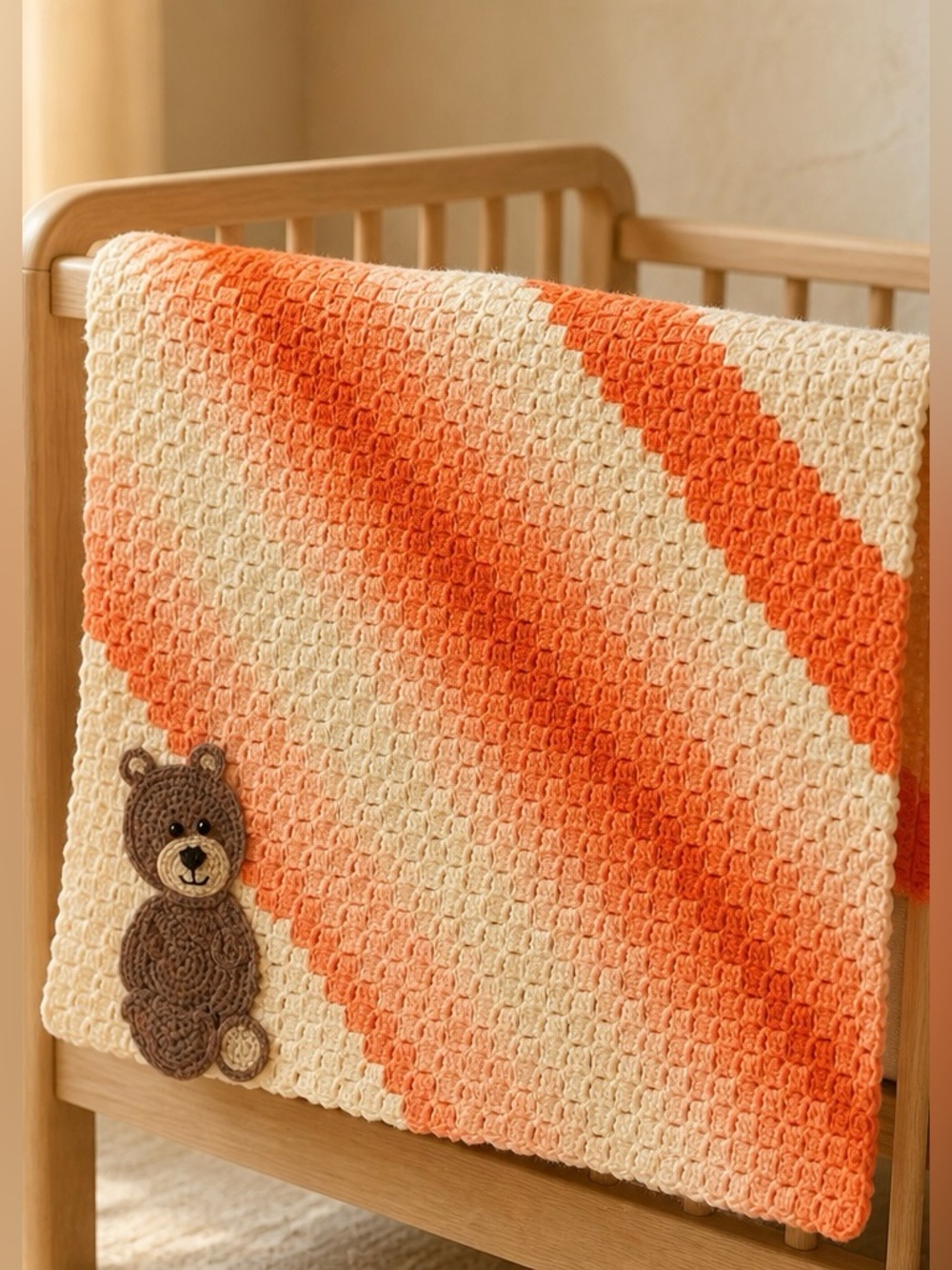 Orange and White Crocheted Ombre Baby Blanket With Brown Bear Emblem